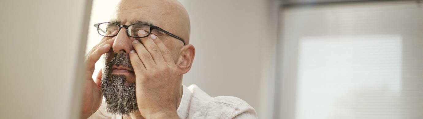 Man rubbing his eyes Man rubbing his eyes