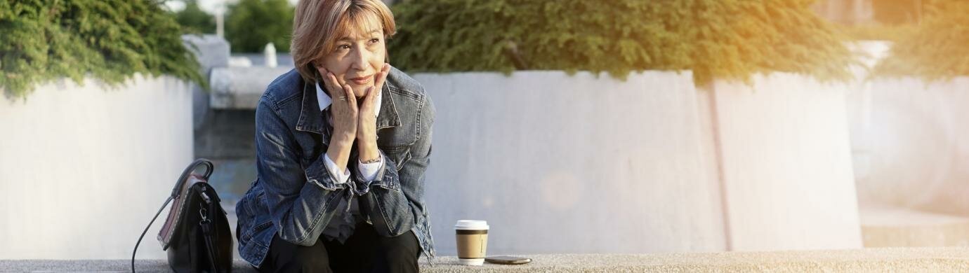 Woman on stone ledge Woman on stone ledge